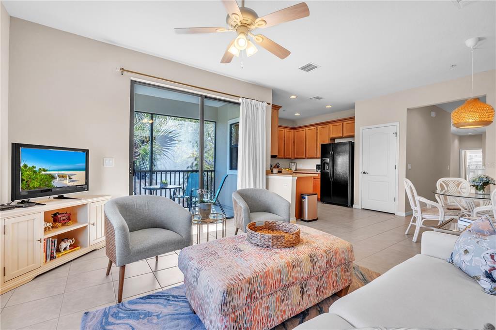 7250 Hamilton Road, Unit 7250 Bradenton, FL 34209 - Photo 7 of 34 a living room with furniture a fireplace and a flat screen tv