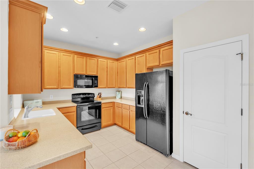 7250 Hamilton Road, Unit 7250 Bradenton, FL 34209 - Photo 10 of 34 a kitchen with stainless steel appliances granite countertop a refrigerator stove top oven a sink and dishwasher