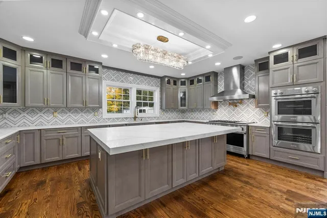 a view of an empty room with wooden floor and window