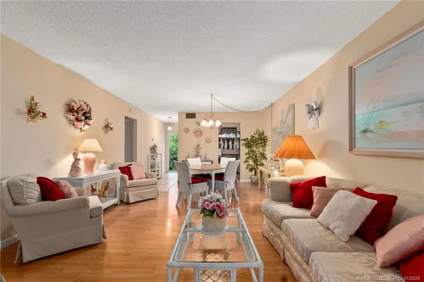 a living room with furniture a rug and a lamp