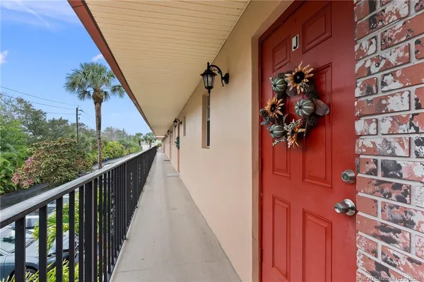 a view of a balcony with wooden floor and stairs