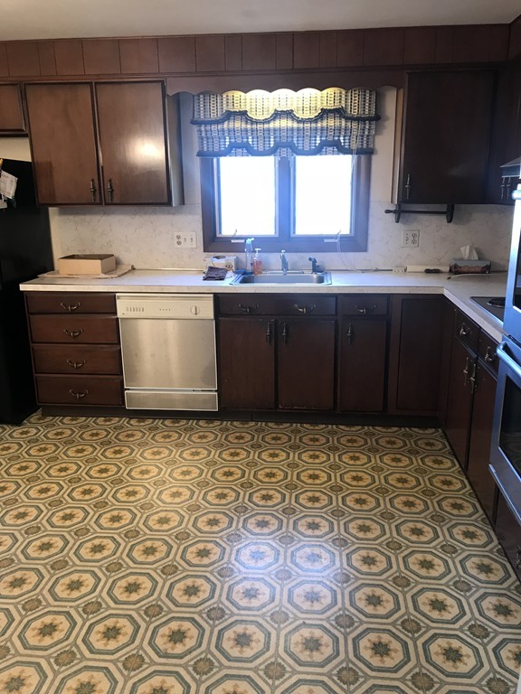 32 Jane Road Marblehead, MA 01945 - Photo 2 of 9 a kitchen with a stove a sink and a window