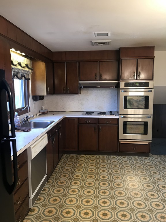32 Jane Road Marblehead, MA 01945 - Photo 3 of 9 a kitchen with stainless steel appliances granite countertop a sink stove and cabinets