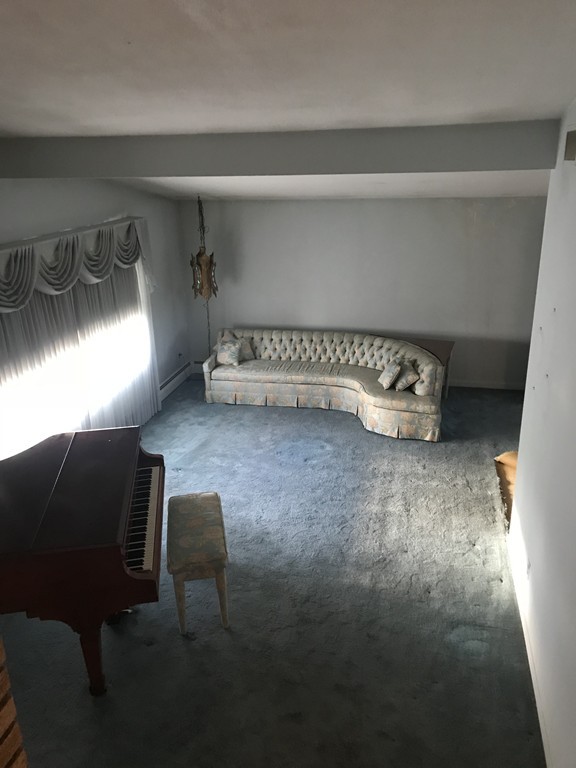 32 Jane Road Marblehead, MA 01945 - Photo 4 of 9 a room with a couch and a table