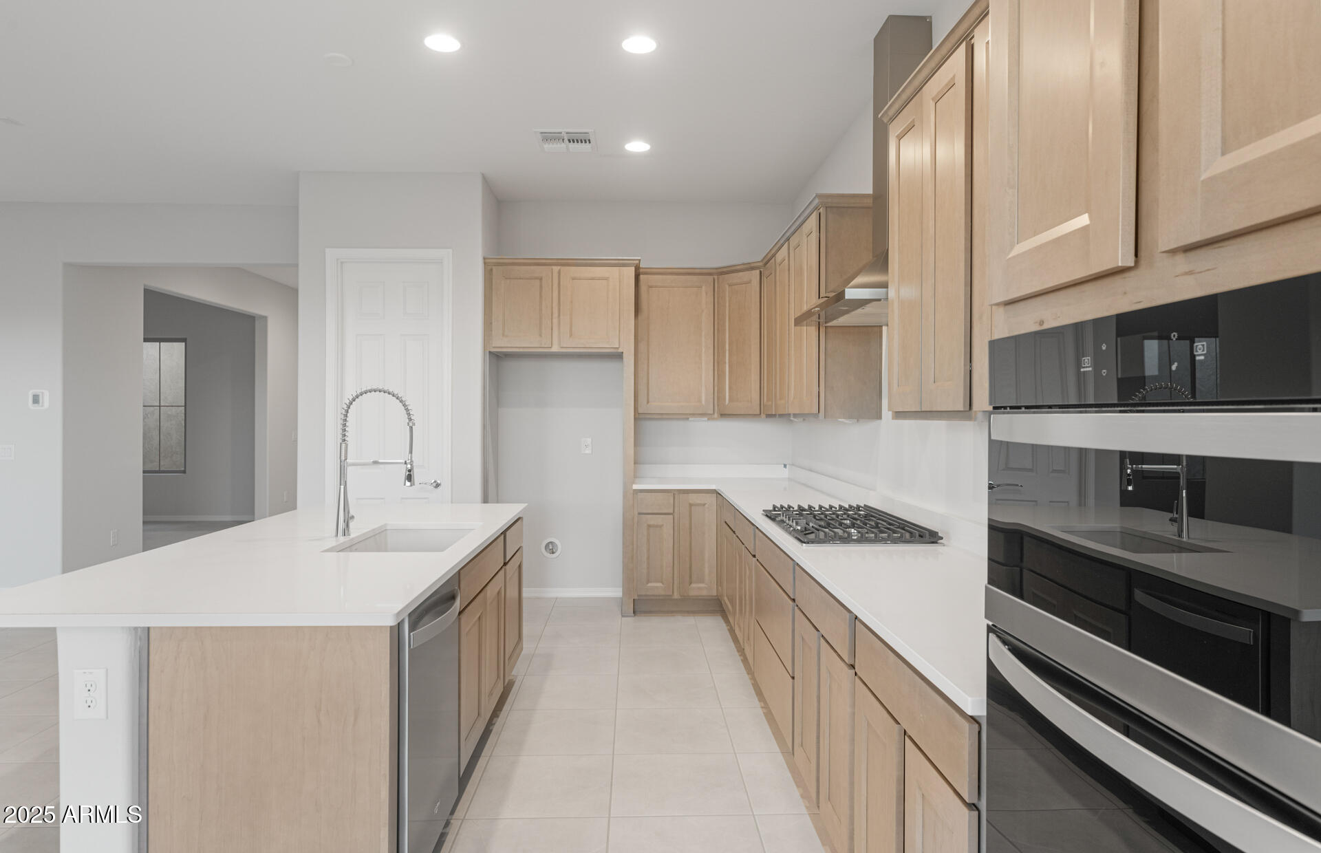 16170 West Red Bird Road Surprise, AZ 85387 - Photo 14 of 27 a kitchen with granite countertop a sink and cabinets
