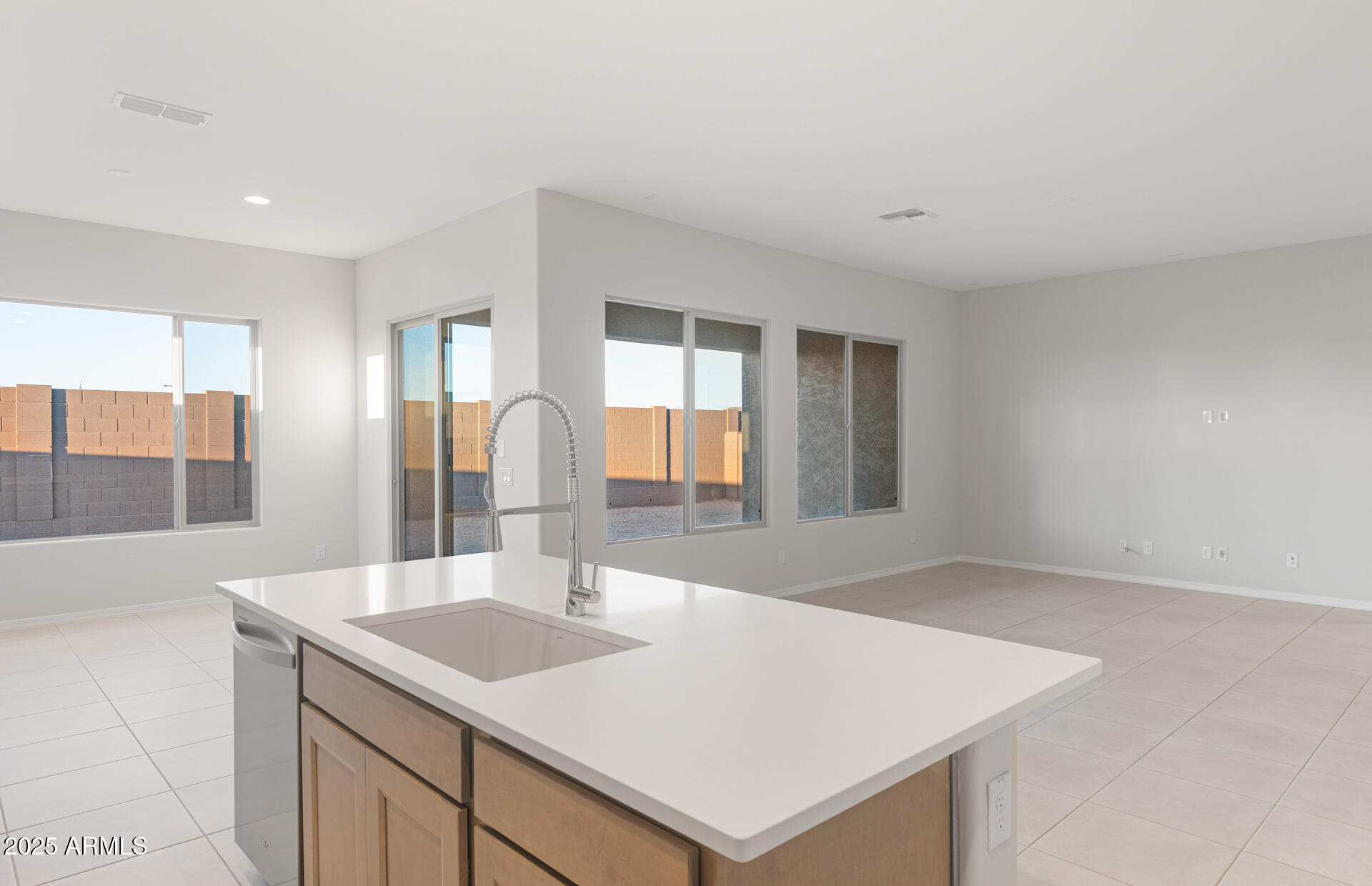 16170 West Red Bird Road Surprise, AZ 85387 - Photo 15 of 27 a kitchen with a sink a large window and wooden floor