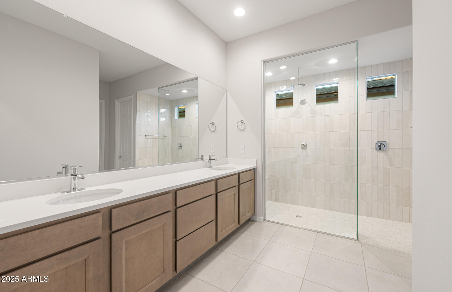 16170 West Red Bird Road Surprise, AZ 85387 - Photo 20 of 27 a bathroom with a double vanity sink mirror and shower