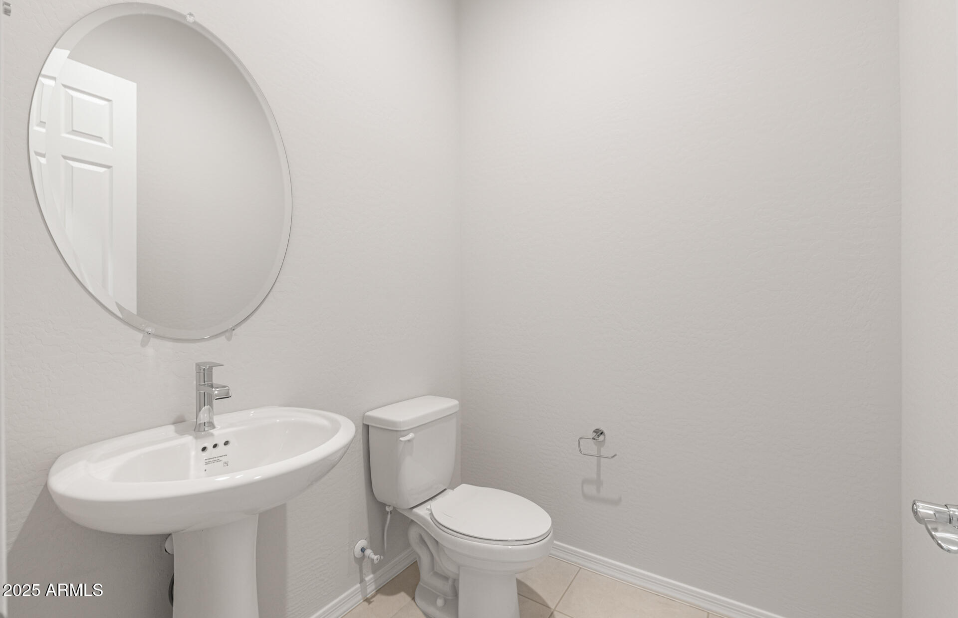 16170 West Red Bird Road Surprise, AZ 85387 - Photo 24 of 27 a bathroom with a toilet a sink and a mirror