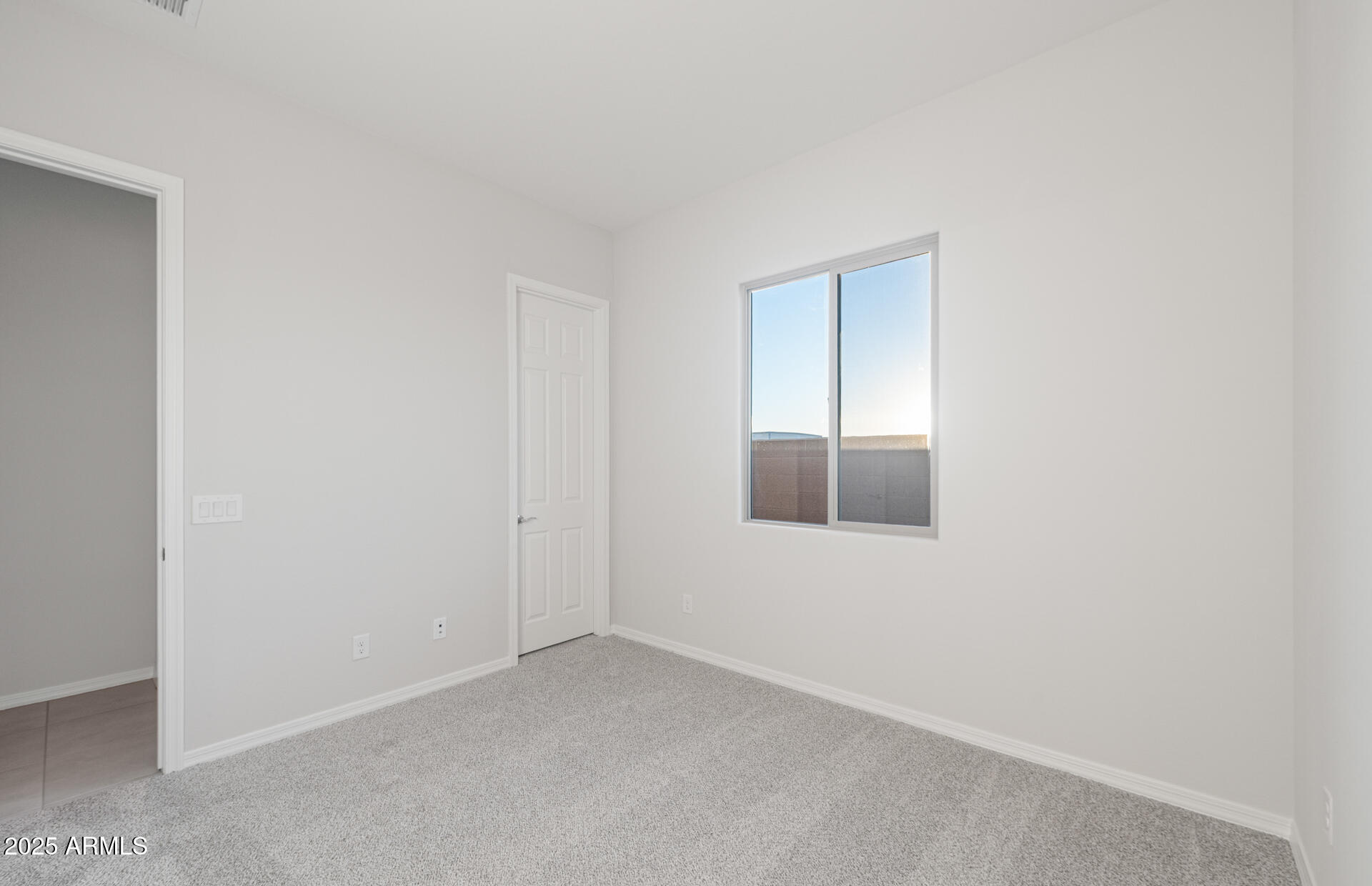 16170 West Red Bird Road Surprise, AZ 85387 - Photo 5 of 27 an empty room with a window