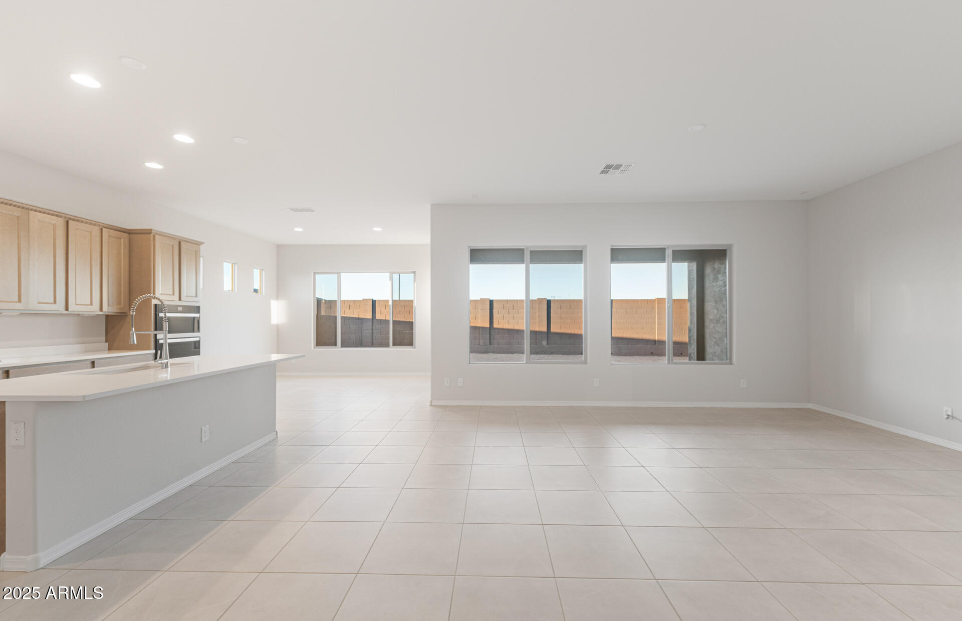 16170 West Red Bird Road Surprise, AZ 85387 - Photo 7 of 27 a large white kitchen with a sink and cabinets