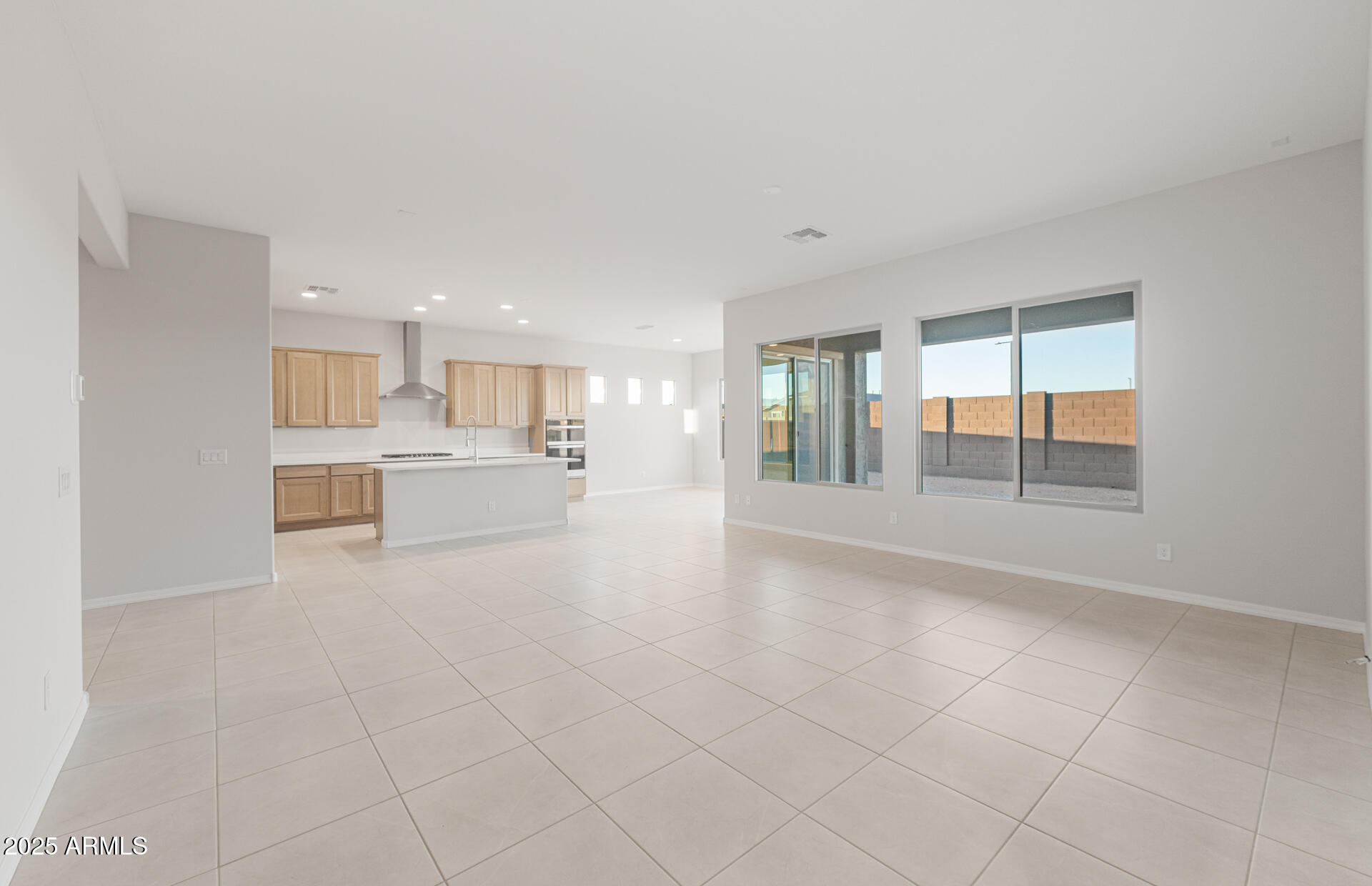 16170 West Red Bird Road Surprise, AZ 85387 - Photo 9 of 27 a view of an empty room with a kitchen