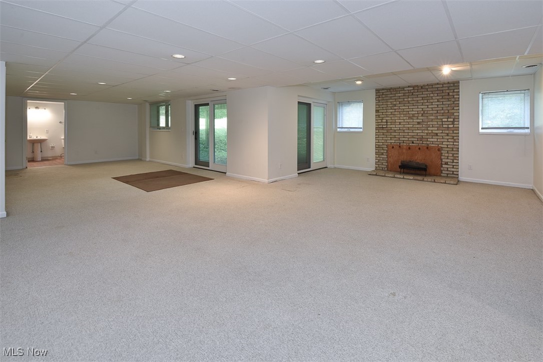 30776 Cedar Road Cleveland, OH 44124 - Photo 36 of 41 Below grade area with a drop ceiling, light carpet, a fireplace, healthy amount of natural light, and recessed lighting