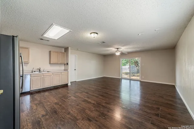 a view of a kitchen with a sink and a stove top oven