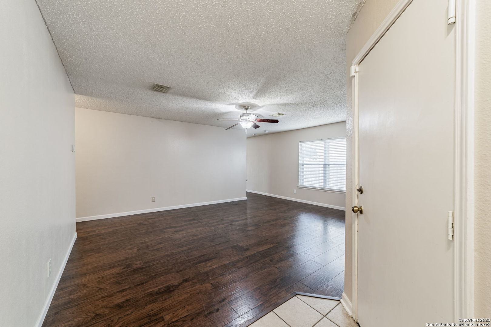 8422 Parry Path Converse, TX 78109 - Photo 2 of 36 an empty room with wooden floor chandelier fan and windows
