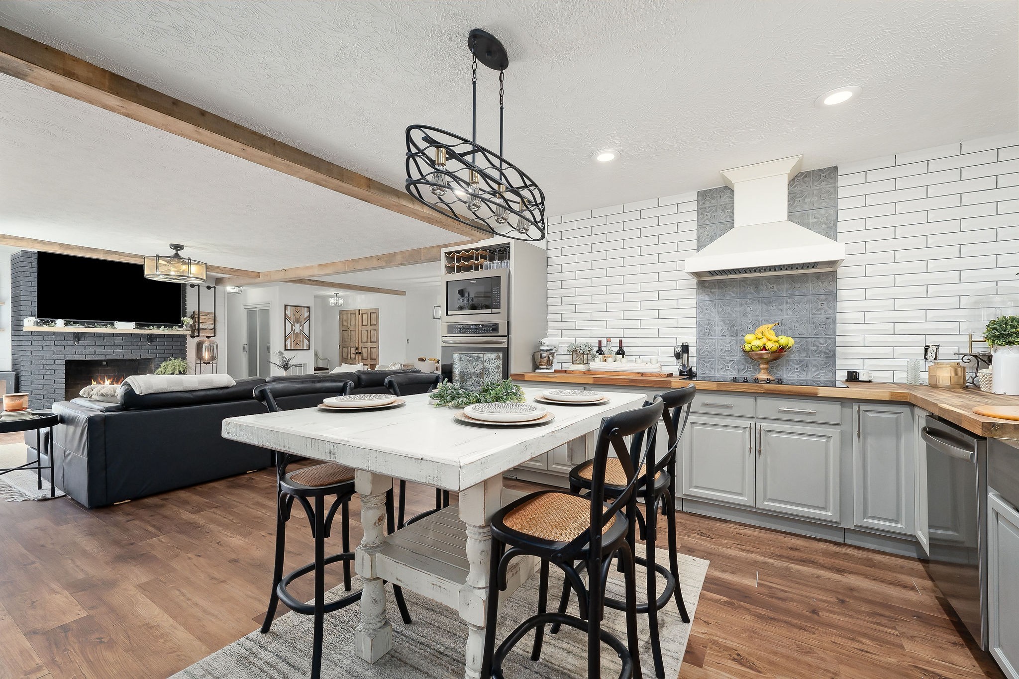 296 Big Rock Road Smithville, TN 37166 - Photo 11 of 32 a kitchen with a stove a sink dining table and chairs