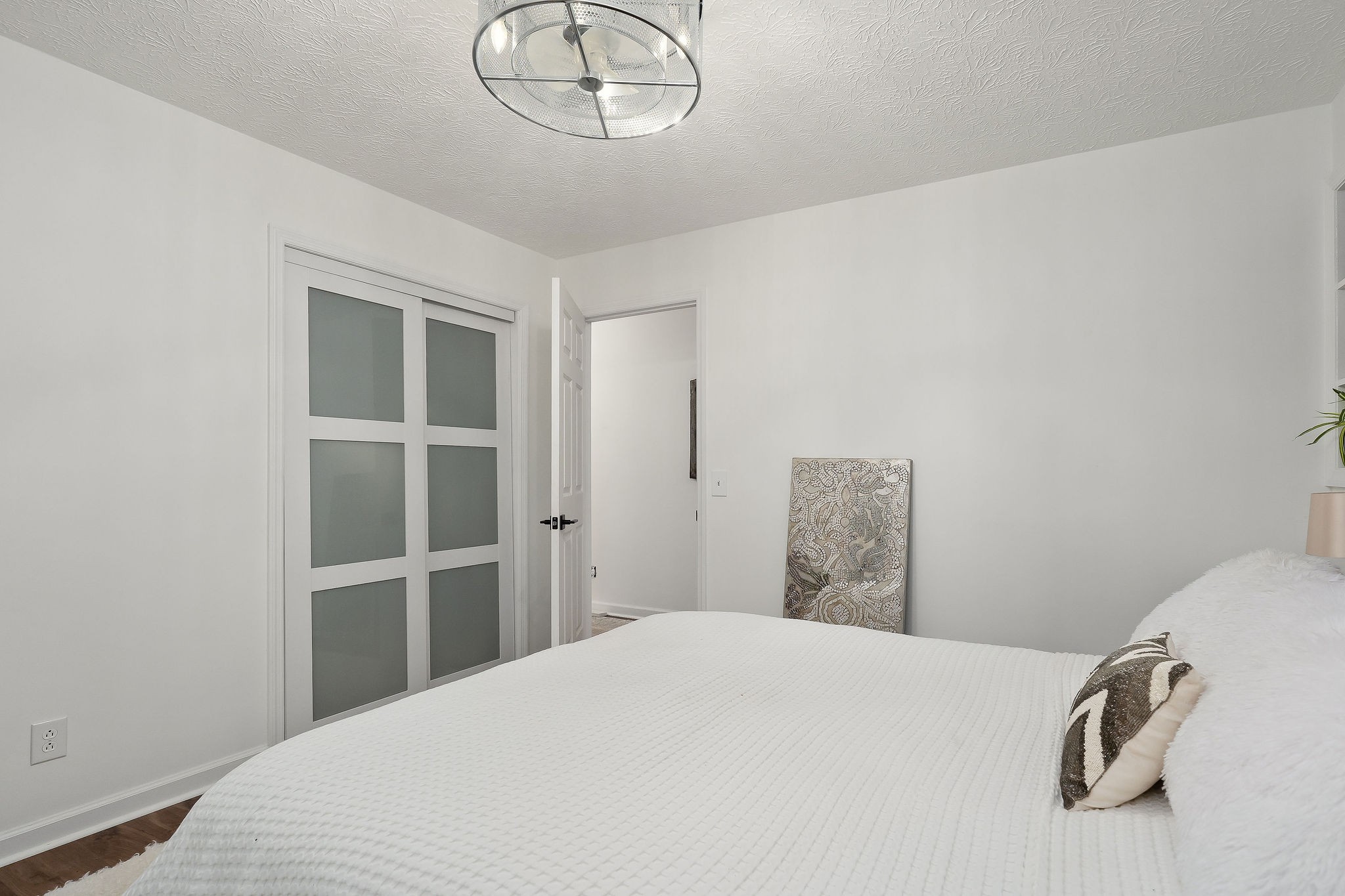 296 Big Rock Road Smithville, TN 37166 - Photo 20 of 32 a bedroom with a bed and a chandelier