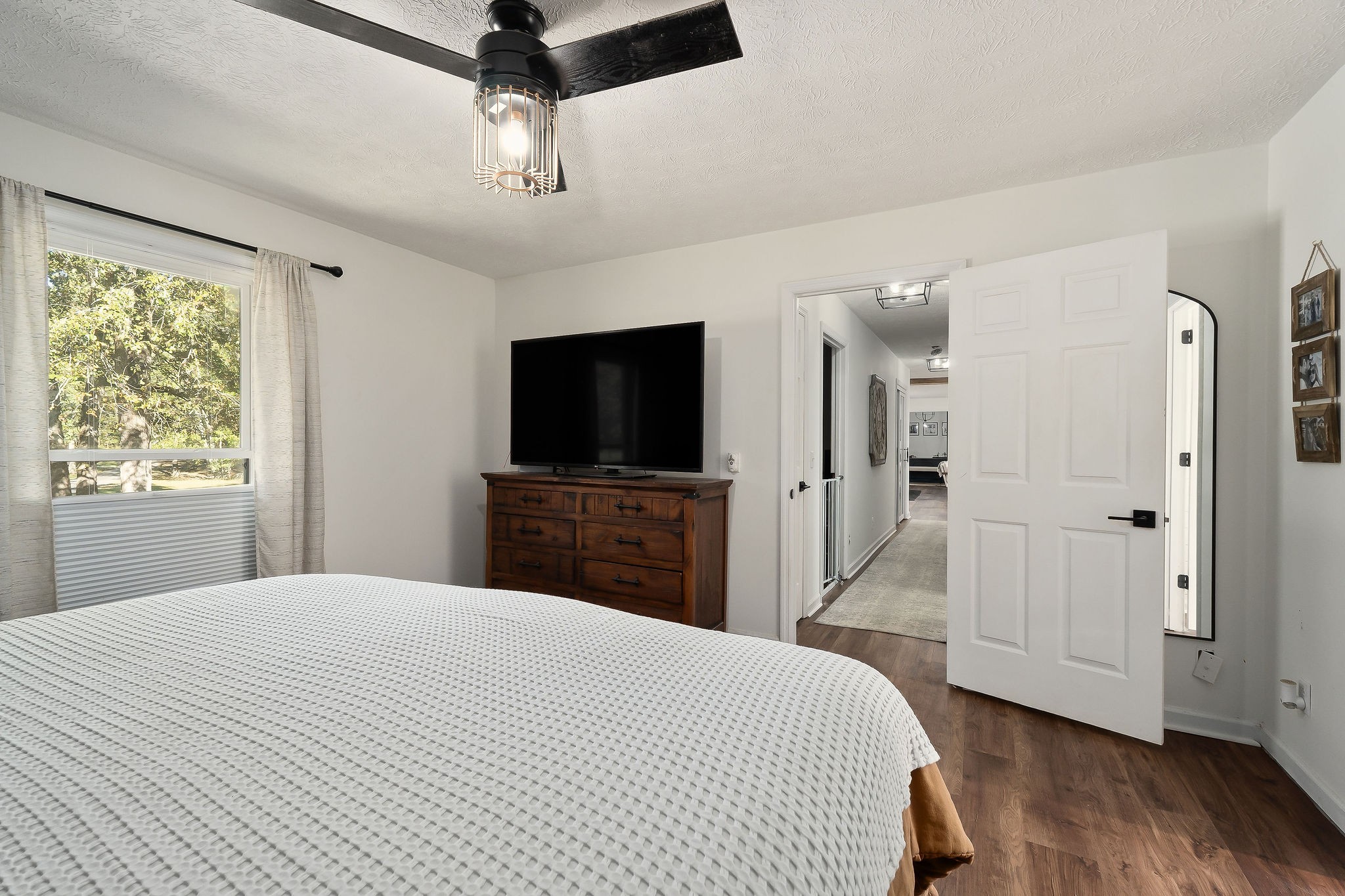 296 Big Rock Road Smithville, TN 37166 - Photo 25 of 32 a bedroom with a bed and a flat screen tv