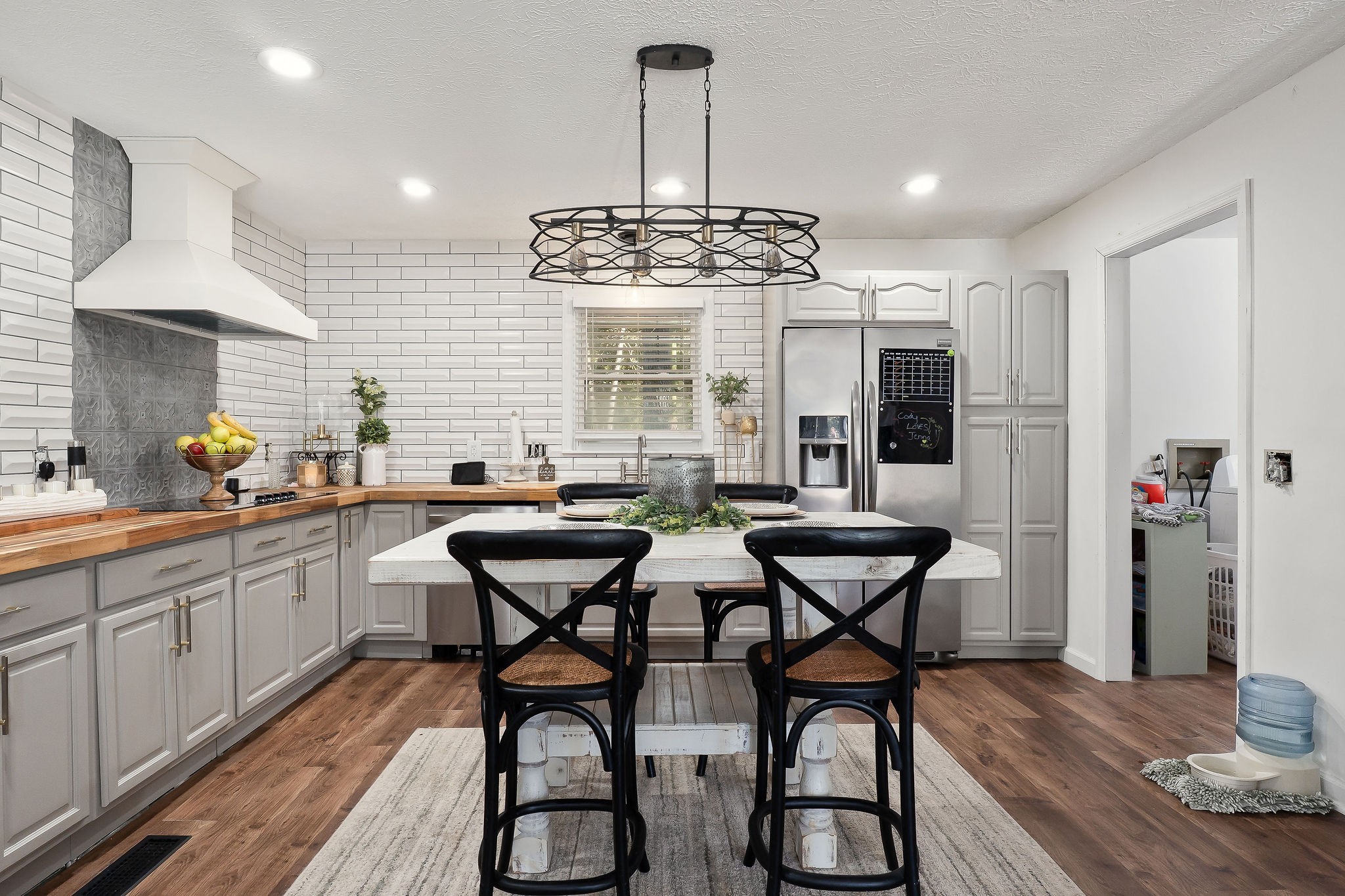296 Big Rock Road Smithville, TN 37166 - Photo 10 of 32 a kitchen with stainless steel appliances a dining table chairs and wooden floor