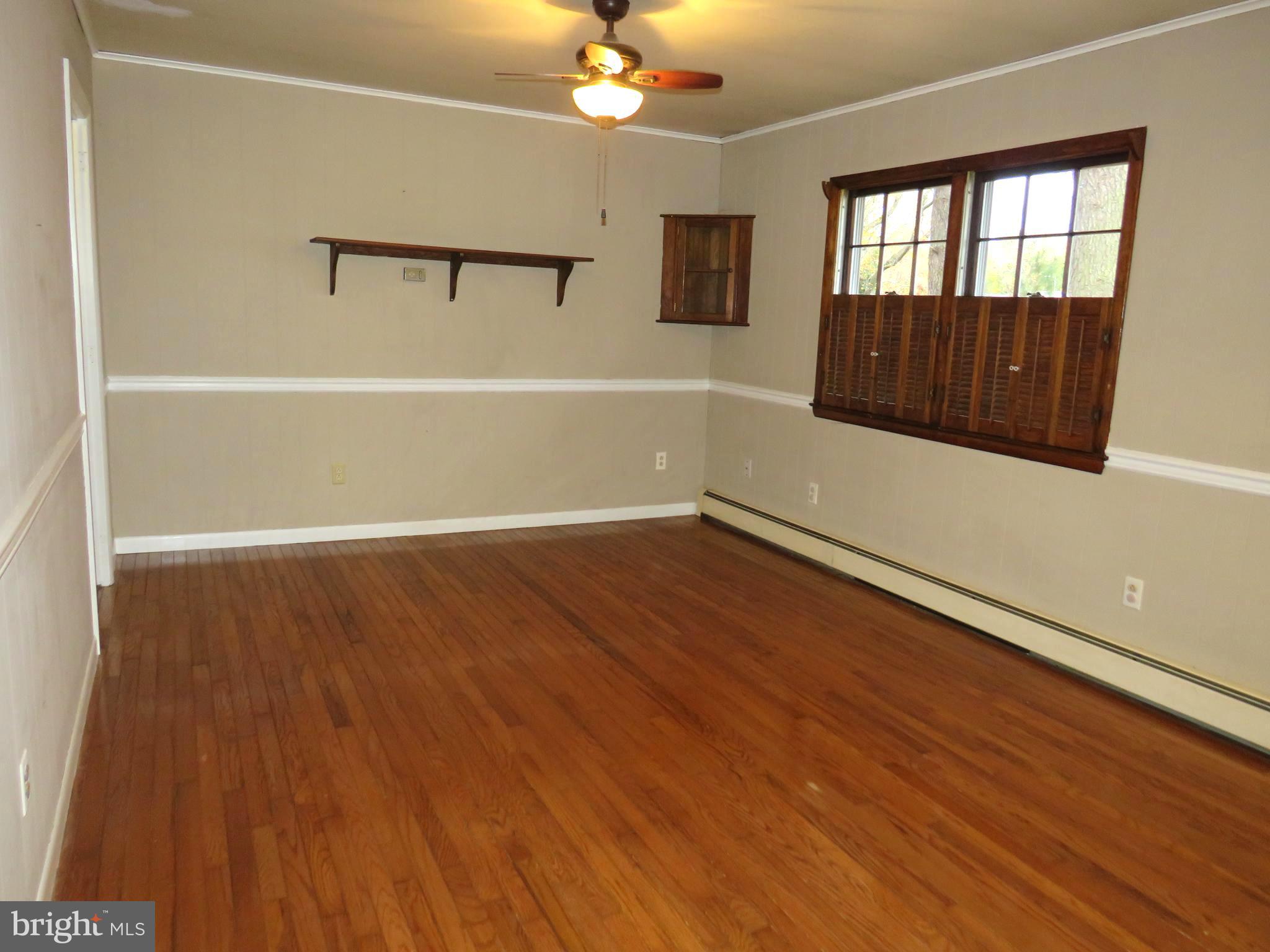 26419 Minden Avenue Crisfield, MD 21817 - Photo 13 of 31 wooden floor in an empty room with a window