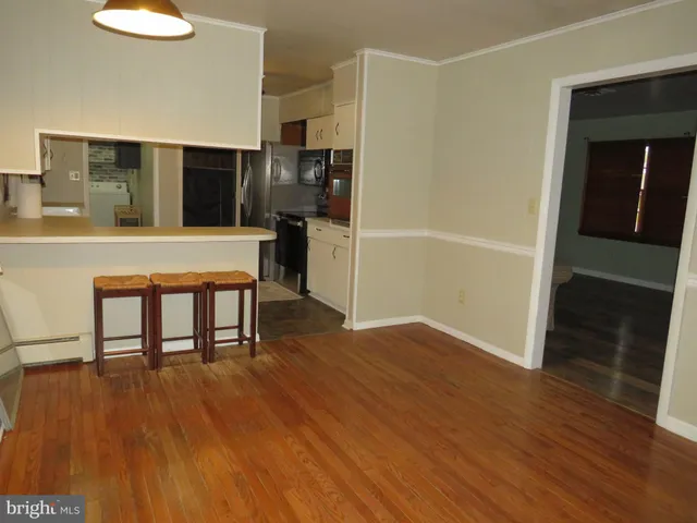 a view of kitchen with furniture and wooden floor