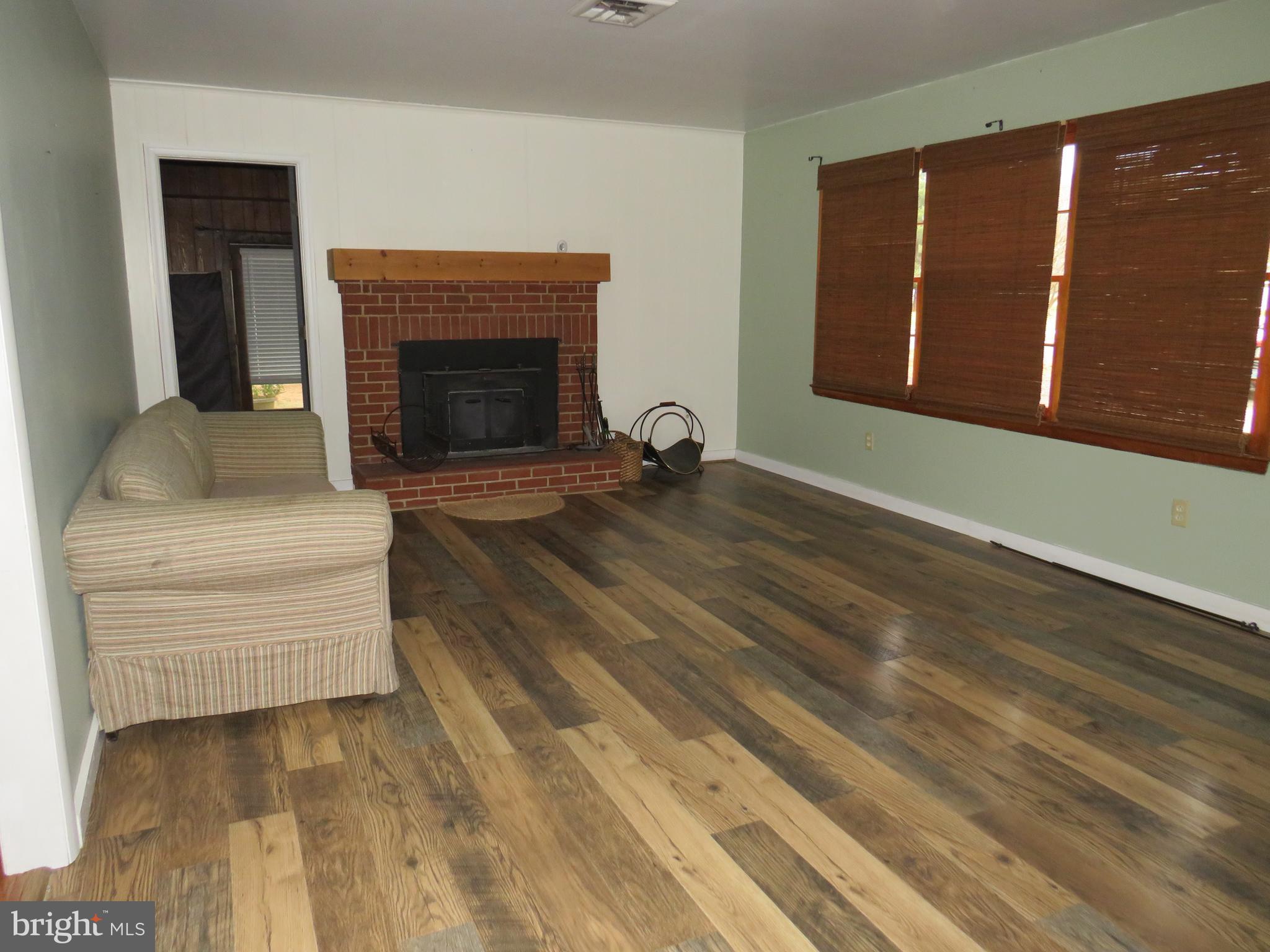 26419 Minden Avenue Crisfield, MD 21817 - Photo 17 of 31 a living room with furniture and a fireplace