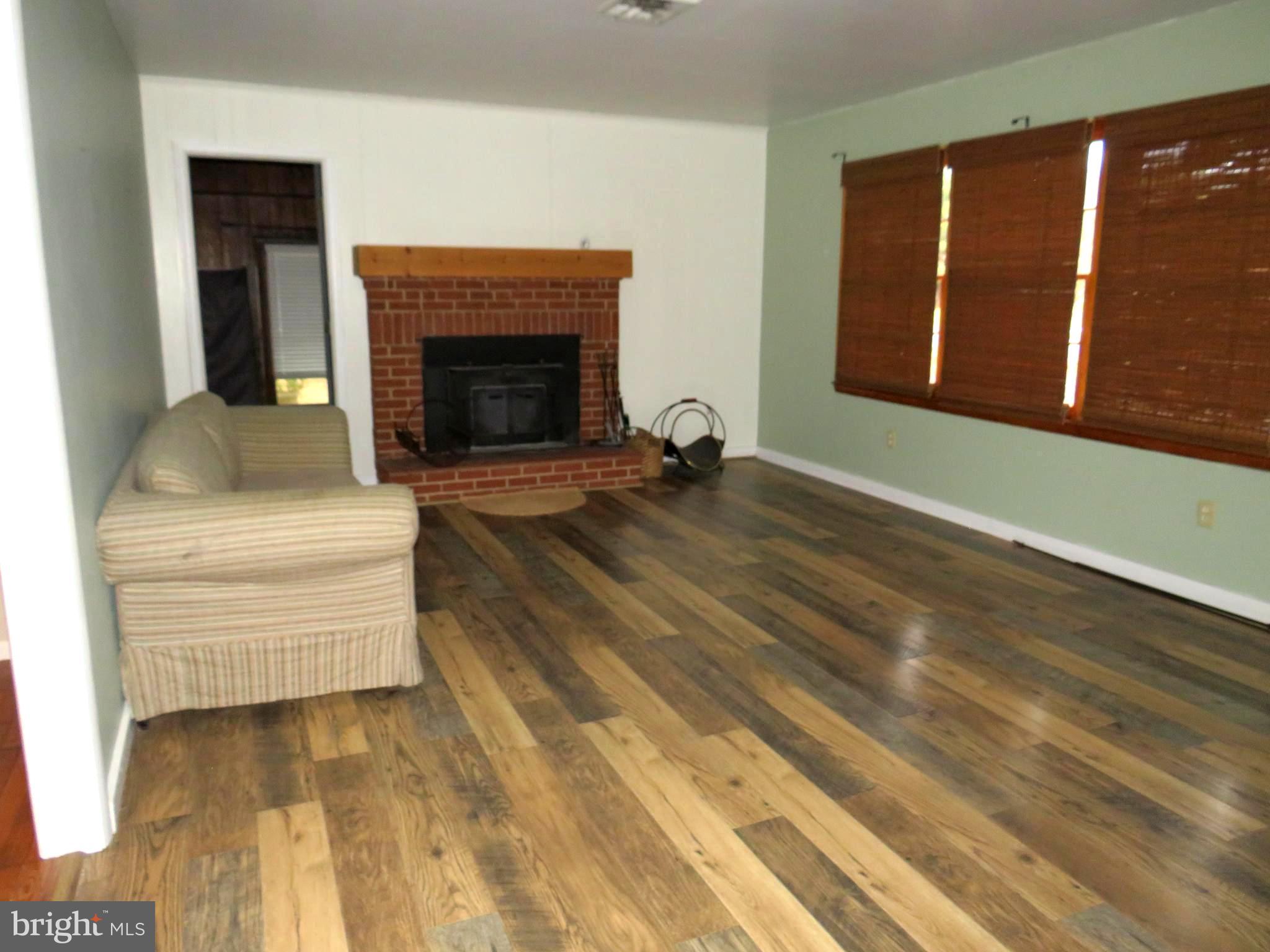 26419 Minden Avenue Crisfield, MD 21817 - Photo 18 of 31 a living room with furniture and a fireplace