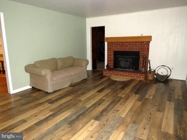 a living room with a fireplace and a wooden floor
