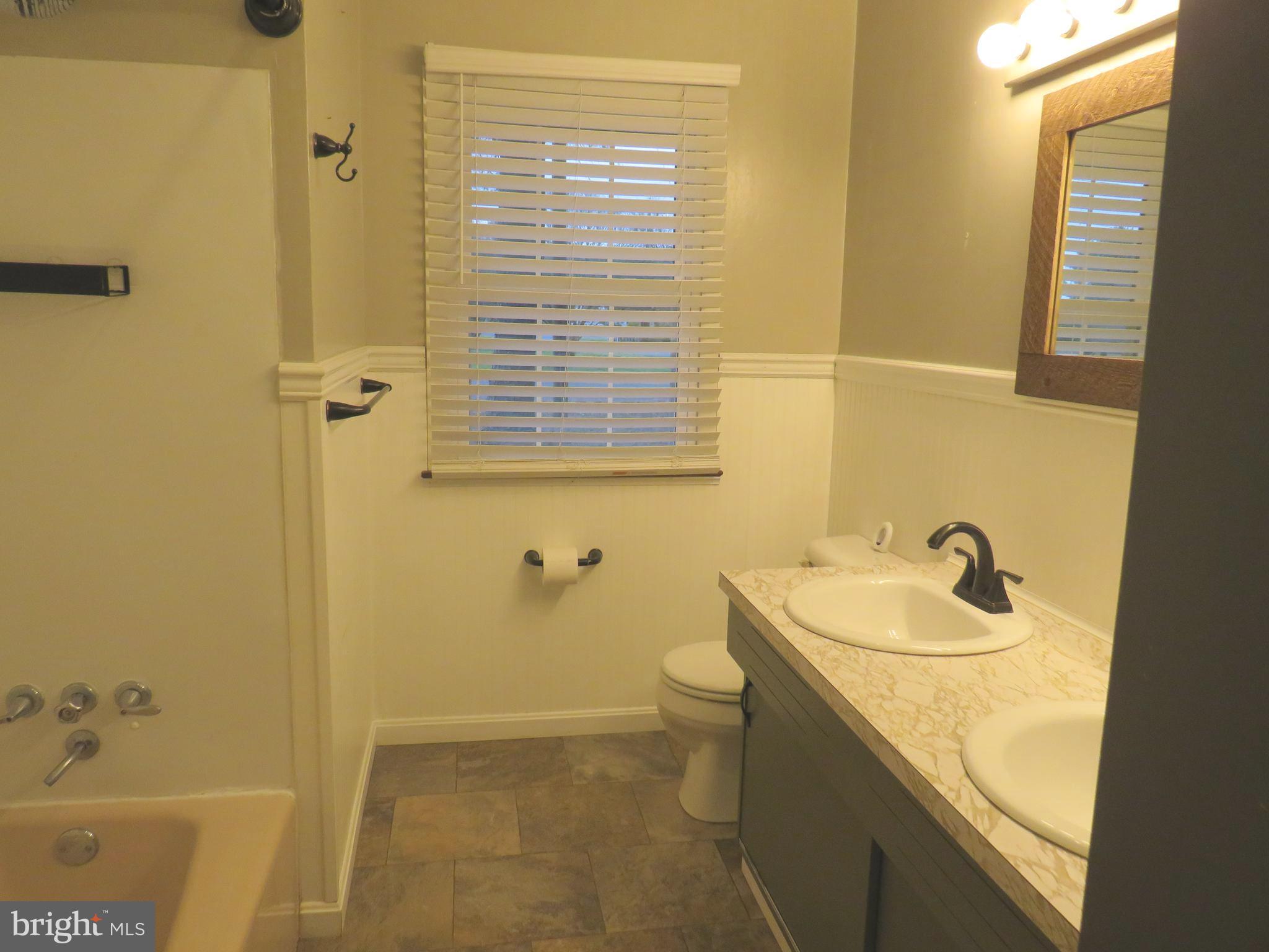 26419 Minden Avenue Crisfield, MD 21817 - Photo 23 of 31 a bathroom with a sink and a tub