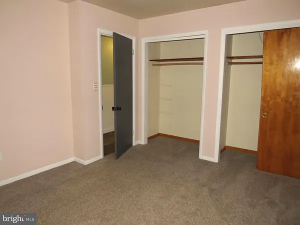 a view of an empty room with closet area