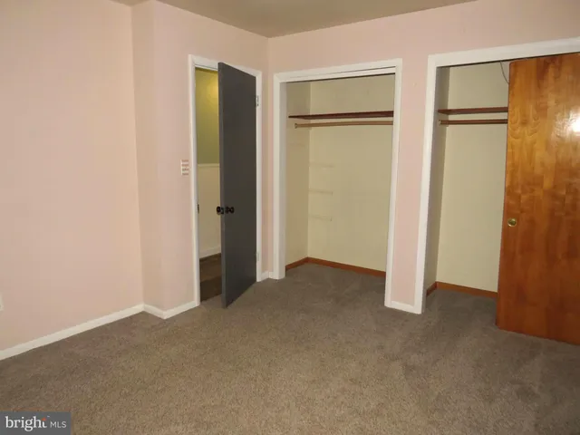 a view of an empty room with closet area