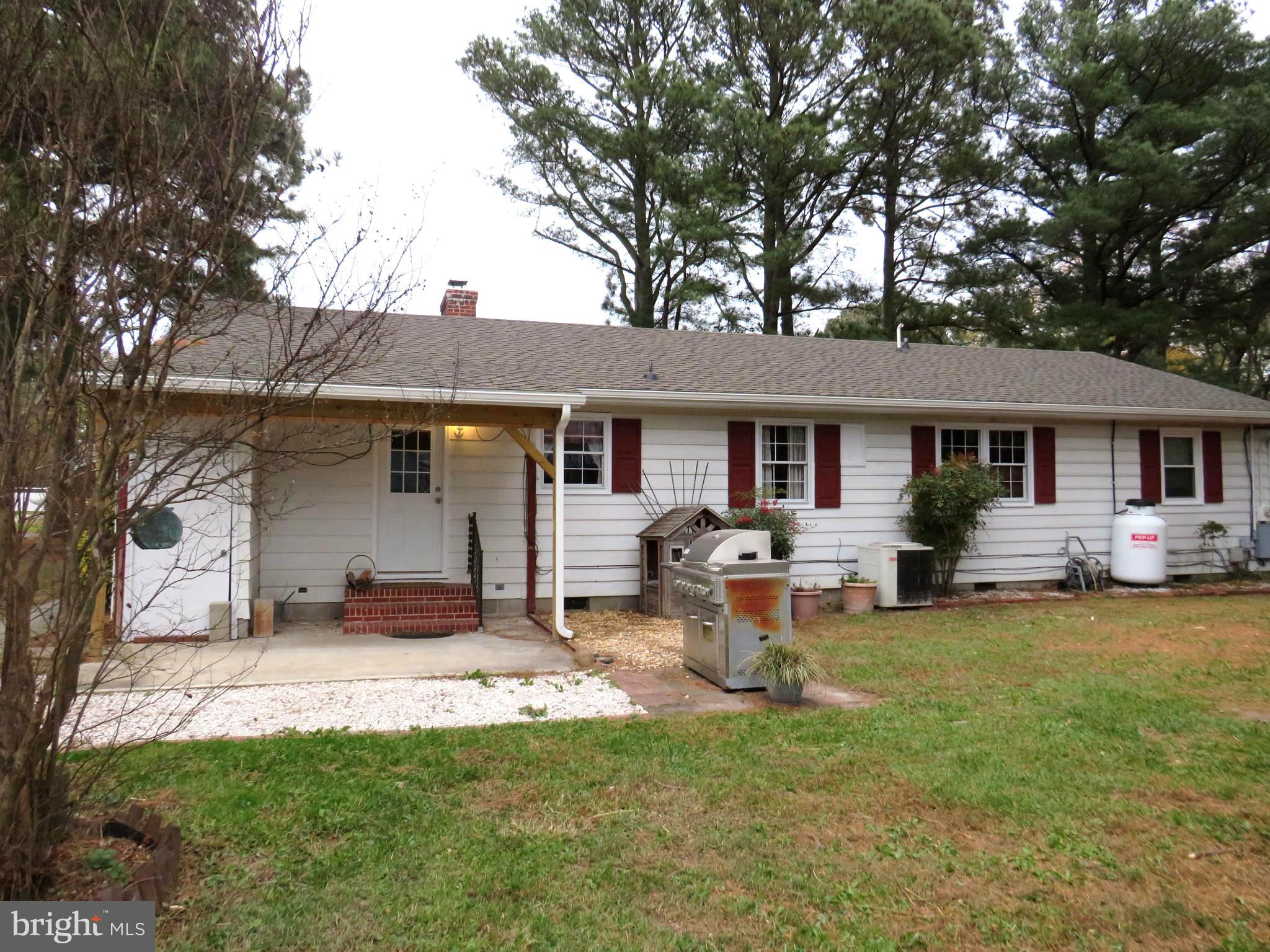 26419 Minden Avenue Crisfield, MD 21817 - Photo 4 of 31 a front view of a house with a garden and trees