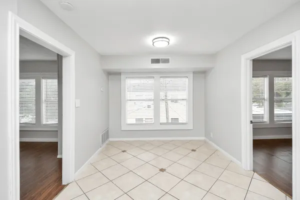 a kitchen with a refrigerator sink and cabinets