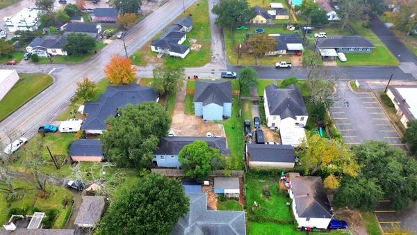 an aerial view of a swimming pool patio and outdoor seating