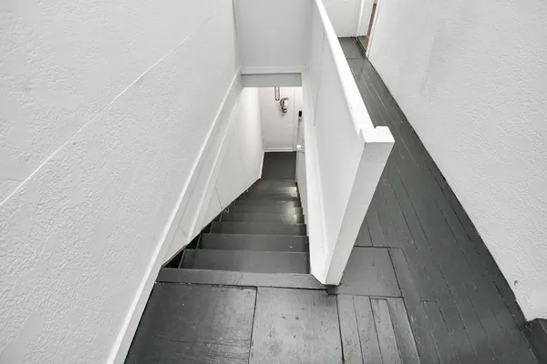 a view of staircase with white walls