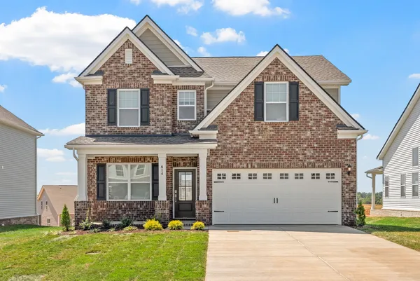 a front view of a house with a yard and garage