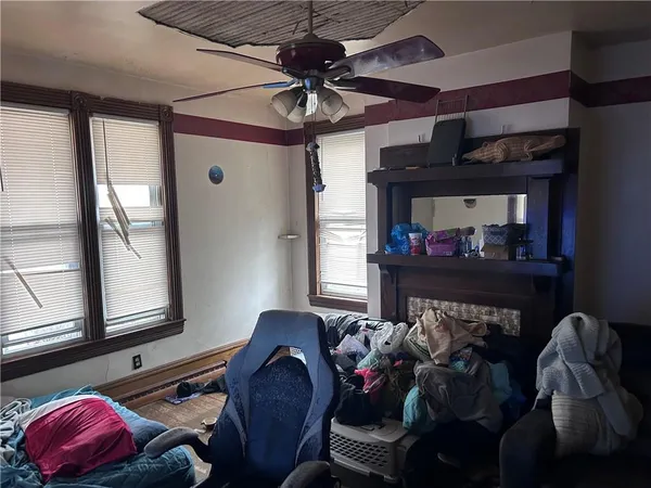 a living room with furniture gym equipment and a mirror