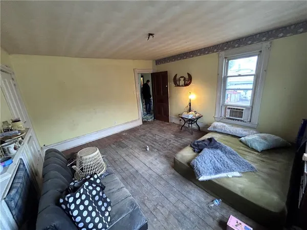 a kitchen with sink a refrigerator and chairs