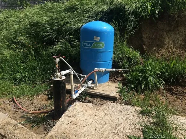 a roof deck with table and chairs and potted plants