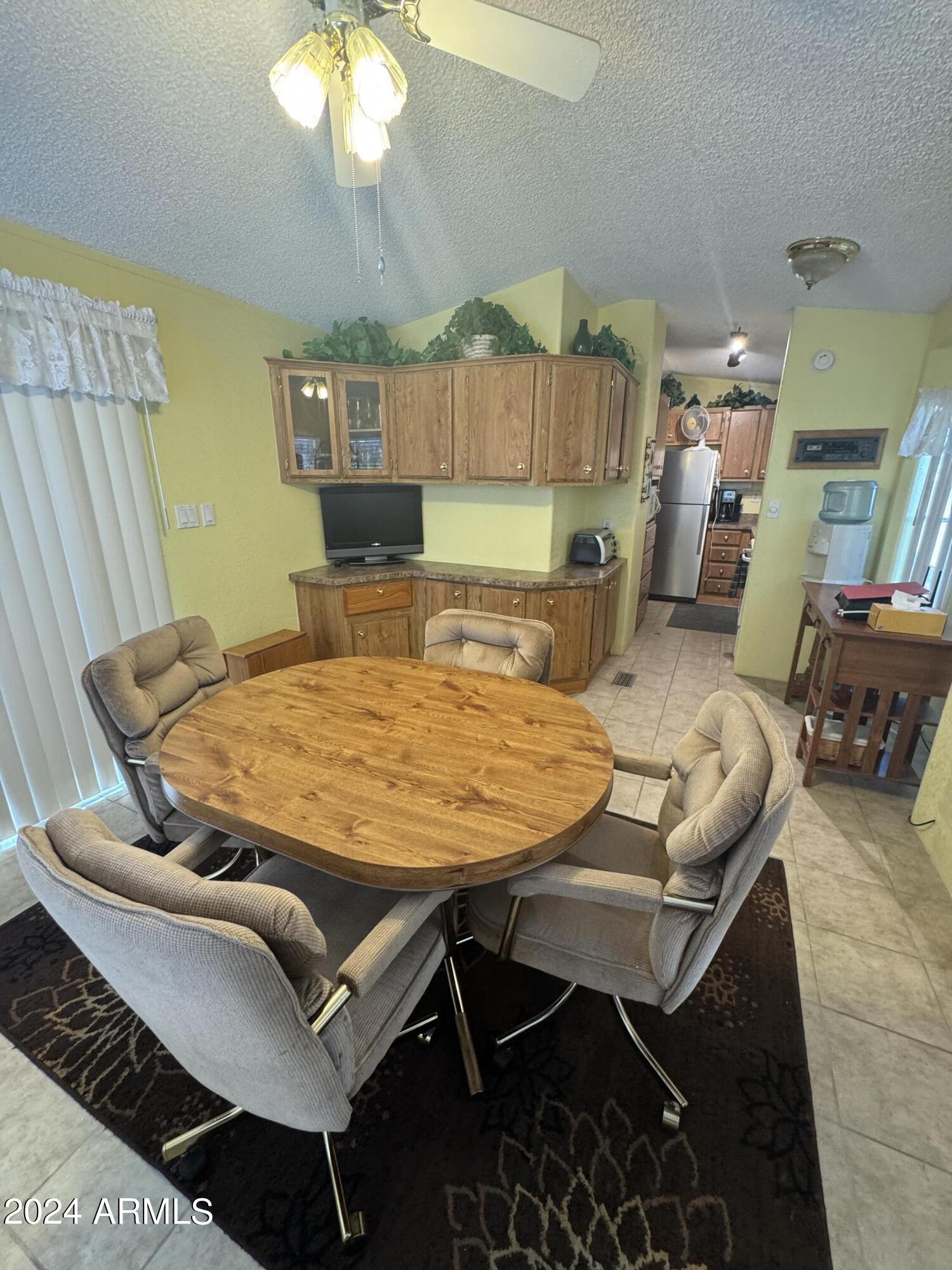 262 West Kiowa Circle Apache Junction, AZ 85119 - Photo 5 of 13 a living room with a table chairs and a chandelier