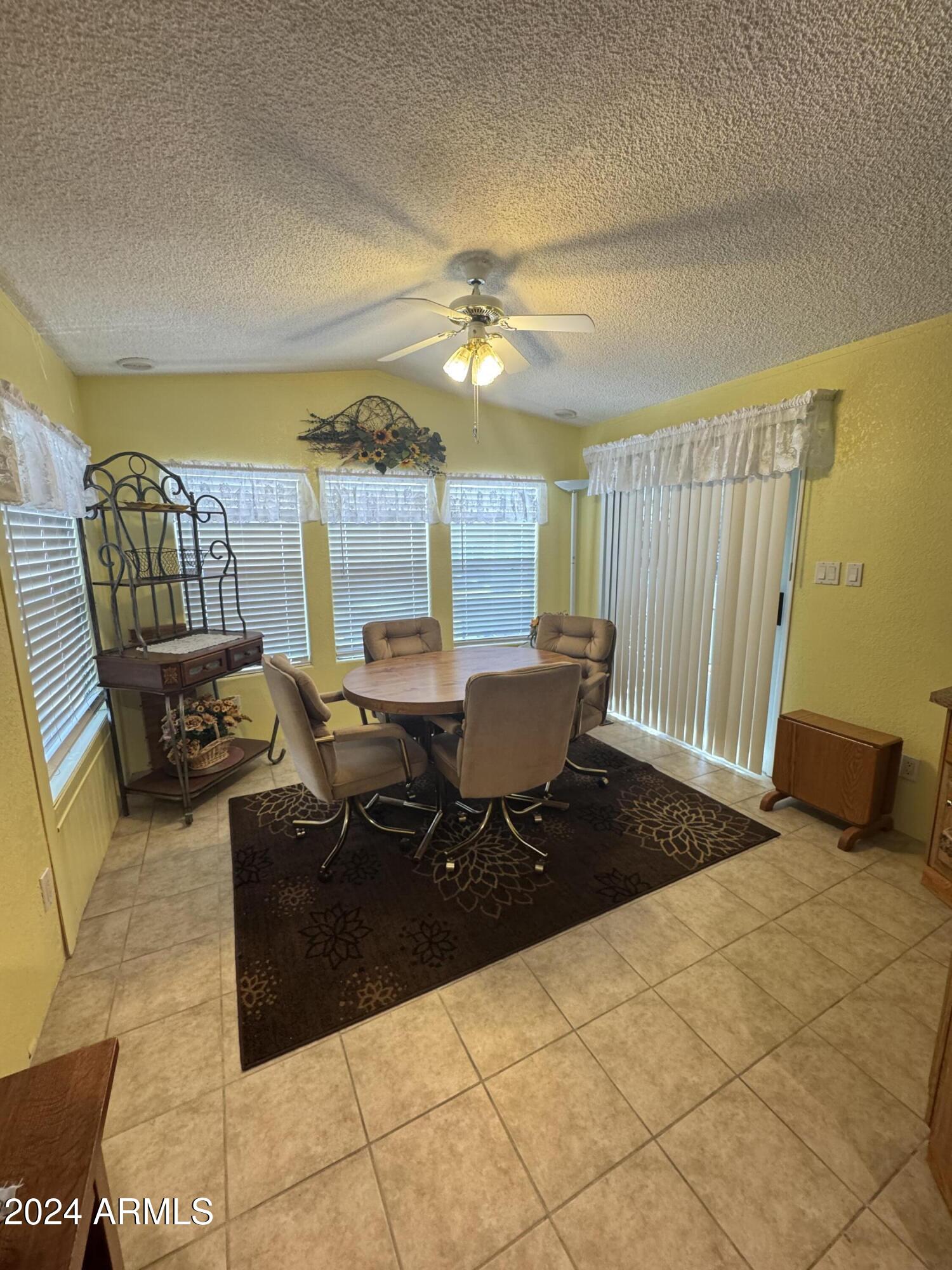 262 West Kiowa Circle Apache Junction, AZ 85119 - Photo 6 of 13 a living room with furniture a rug and a chandelier