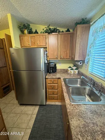 a kitchen with refrigerator and cabinets