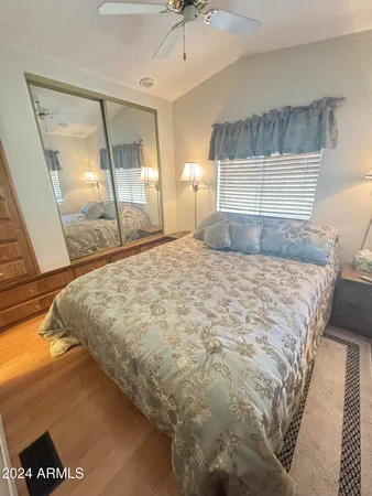 a bedroom with a bed and a mirror
