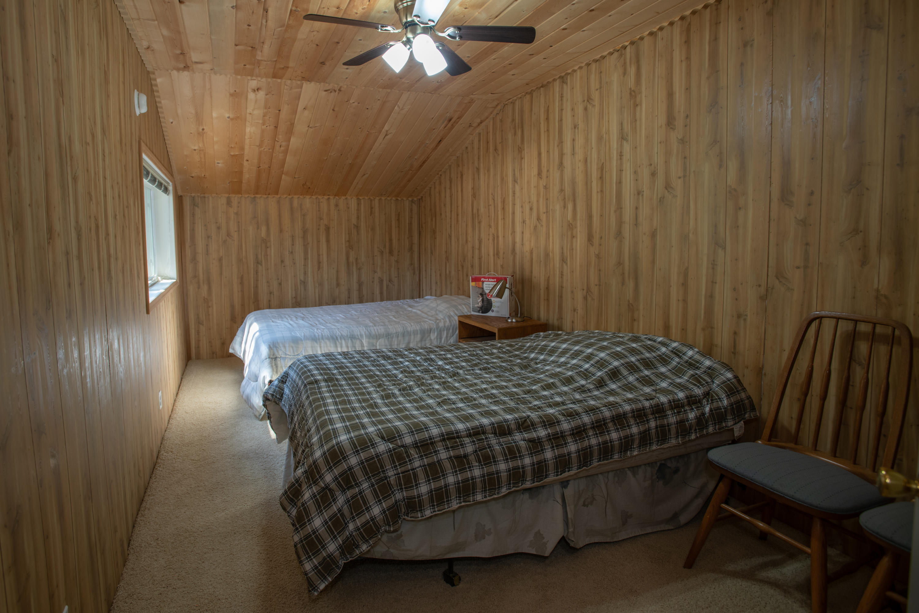 17031 Azusa Road Bend, OR 97707 - Photo 21 of 27 a bedroom with a bed and a chandelier