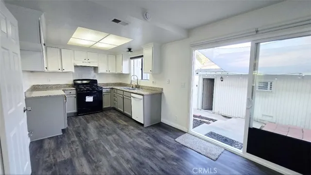 a kitchen with stainless steel appliances granite countertop a stove a sink dishwasher and a refrigerator
