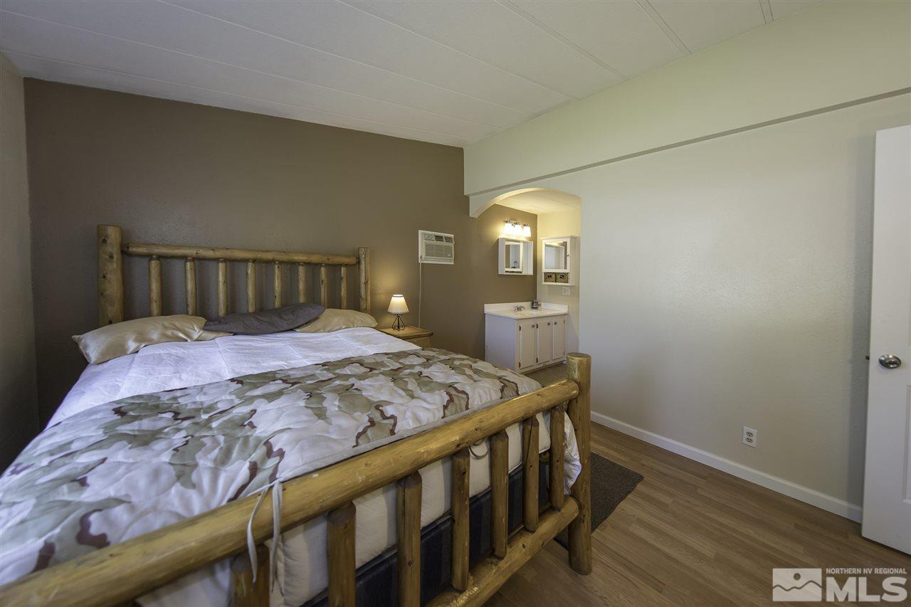 17235 Sunbird Lane Reno, NV 89508 - Photo 11 of 15 a bedroom with a bed and wooden floor