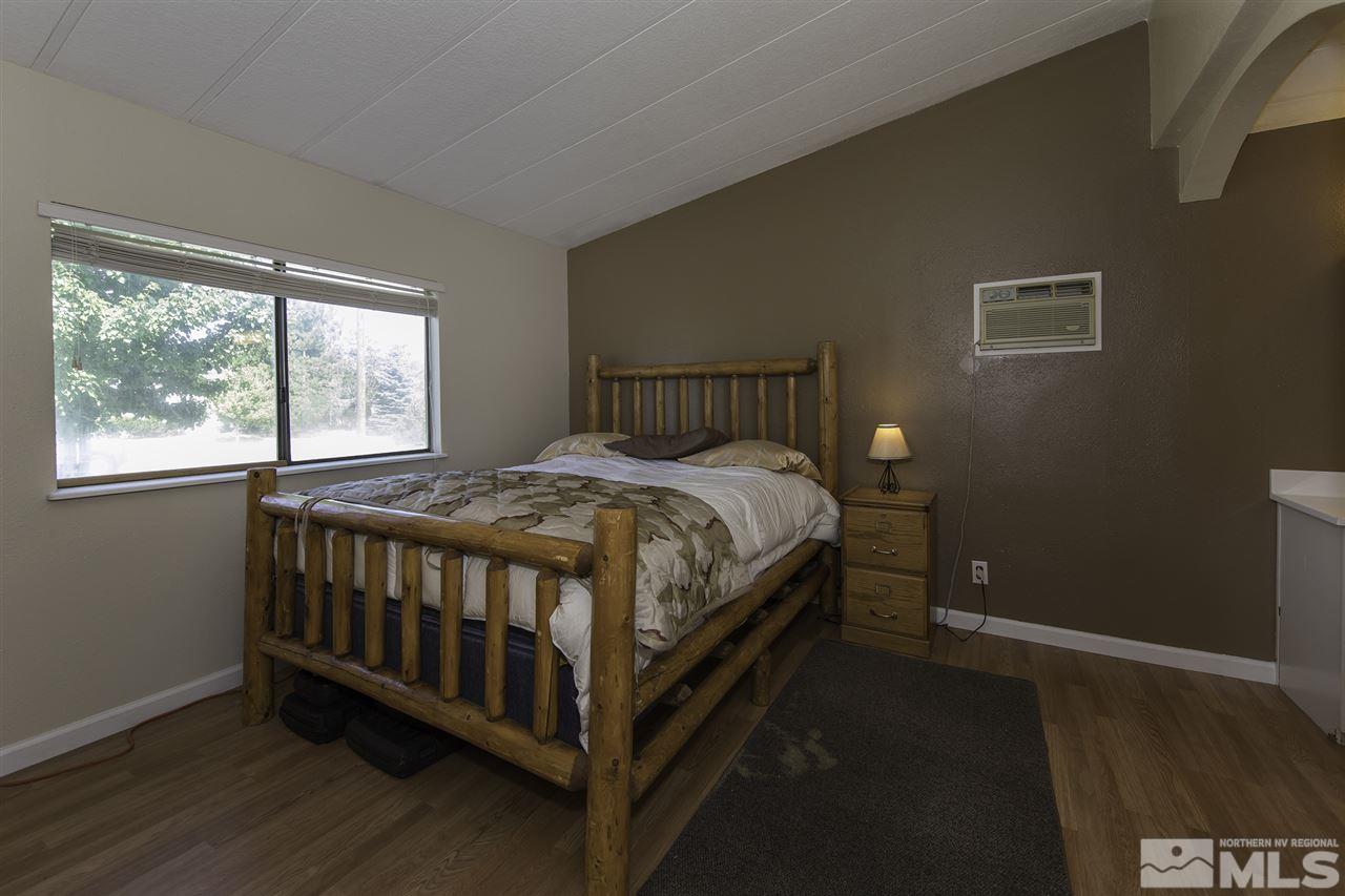 17235 Sunbird Lane Reno, NV 89508 - Photo 12 of 15 a bed sitting in a bedroom next to a window