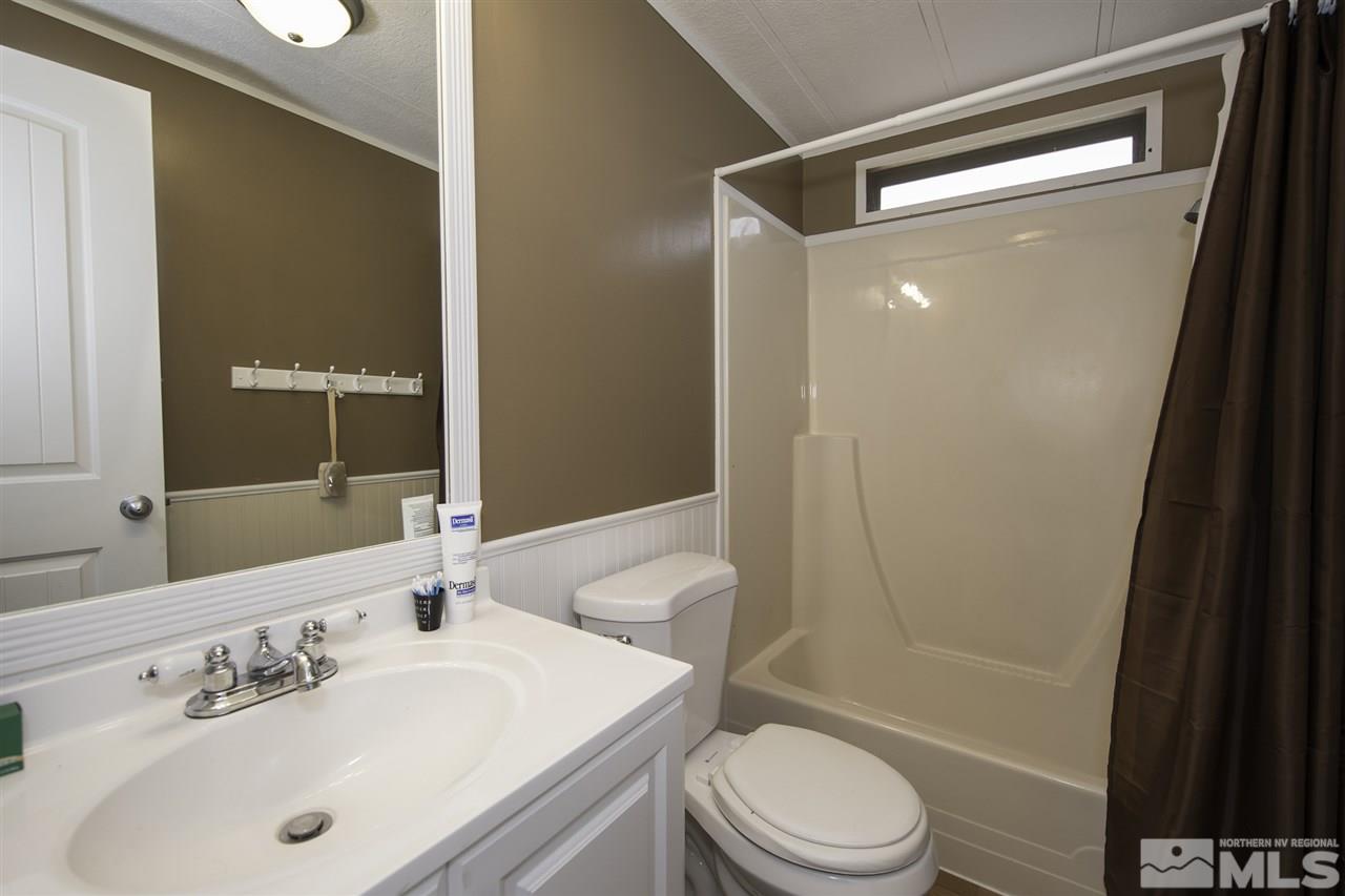 17235 Sunbird Lane Reno, NV 89508 - Photo 14 of 15 a bathroom with a sink a toilet and shower