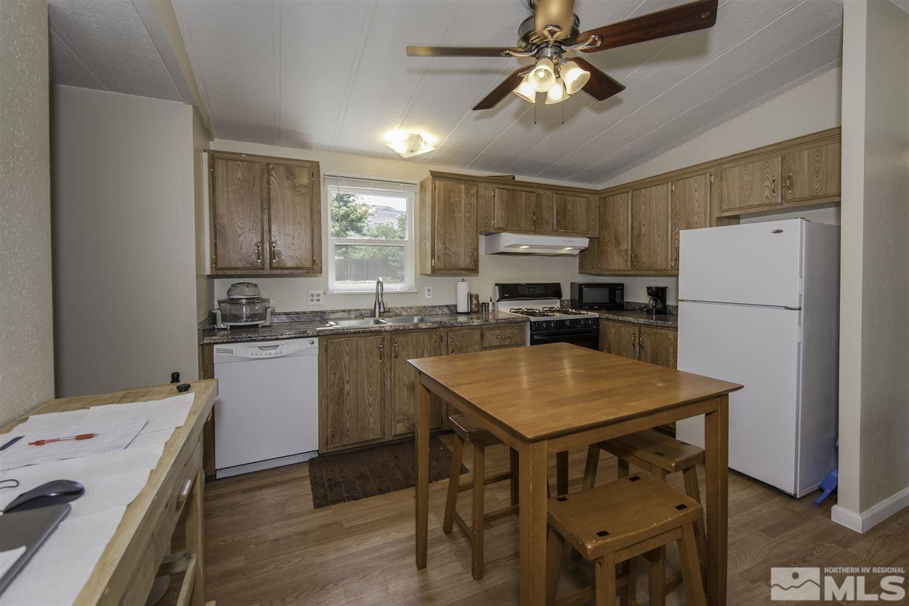17235 Sunbird Lane Reno, NV 89508 - Photo 8 of 15 a kitchen with refrigerator cabinets and wooden floor