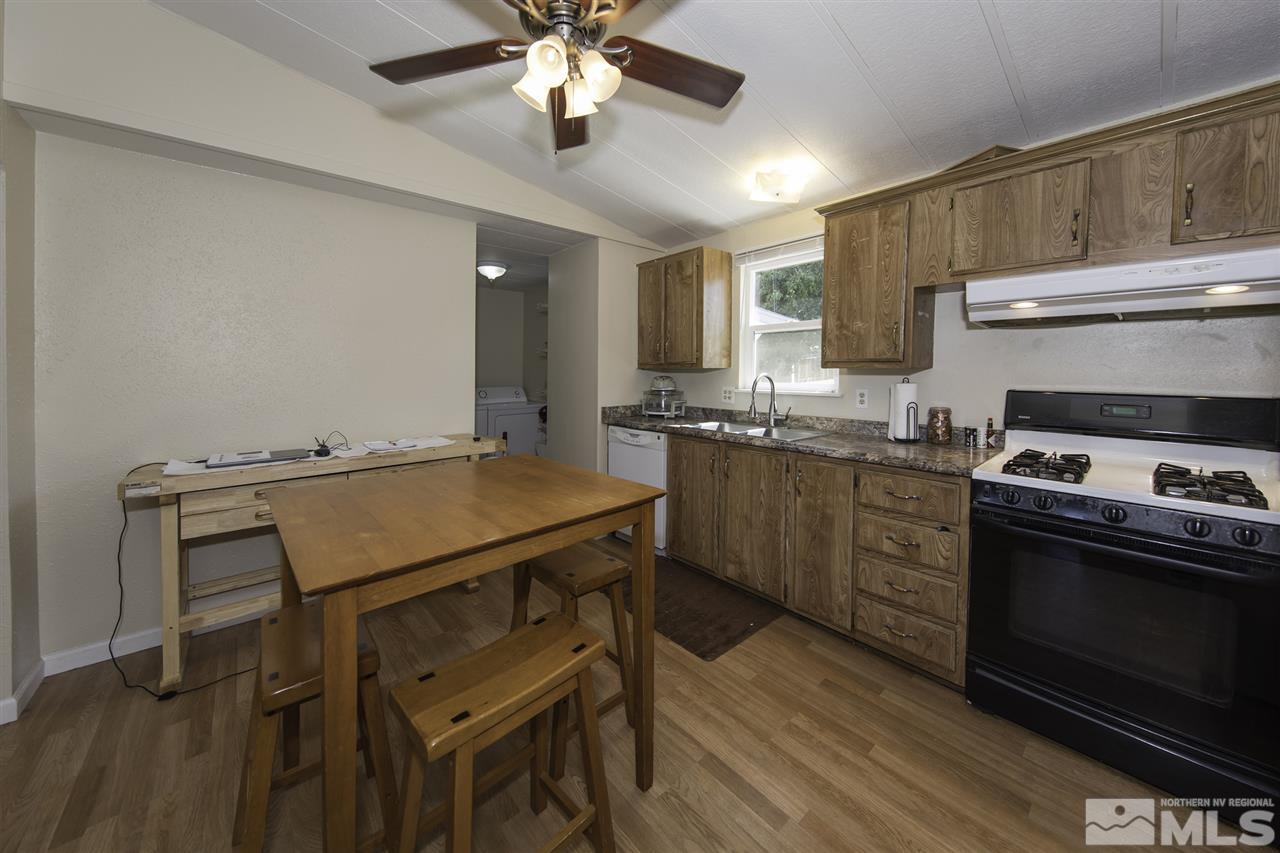 17235 Sunbird Lane Reno, NV 89508 - Photo 9 of 15 a kitchen with a stove a sink and a refrigerator