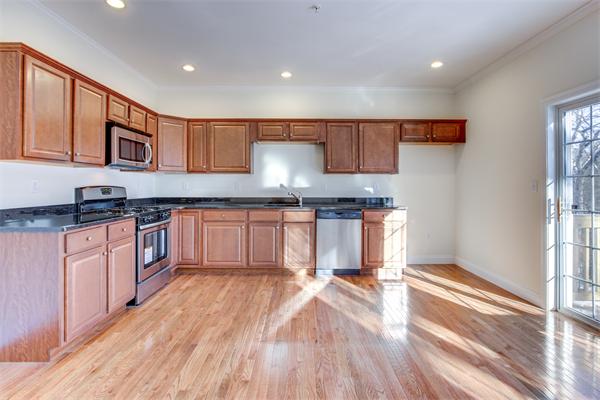 90 Rangeway Road, Unit 203 Billerica, MA 01862 - Photo 12 of 25 a kitchen with granite countertop a stove top oven a sink and cabinets